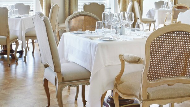 A dining area with tables set for six, elegant chairs, and large windows with curtains. - King George, a Luxury Collection Hotel, Athens (Athens)