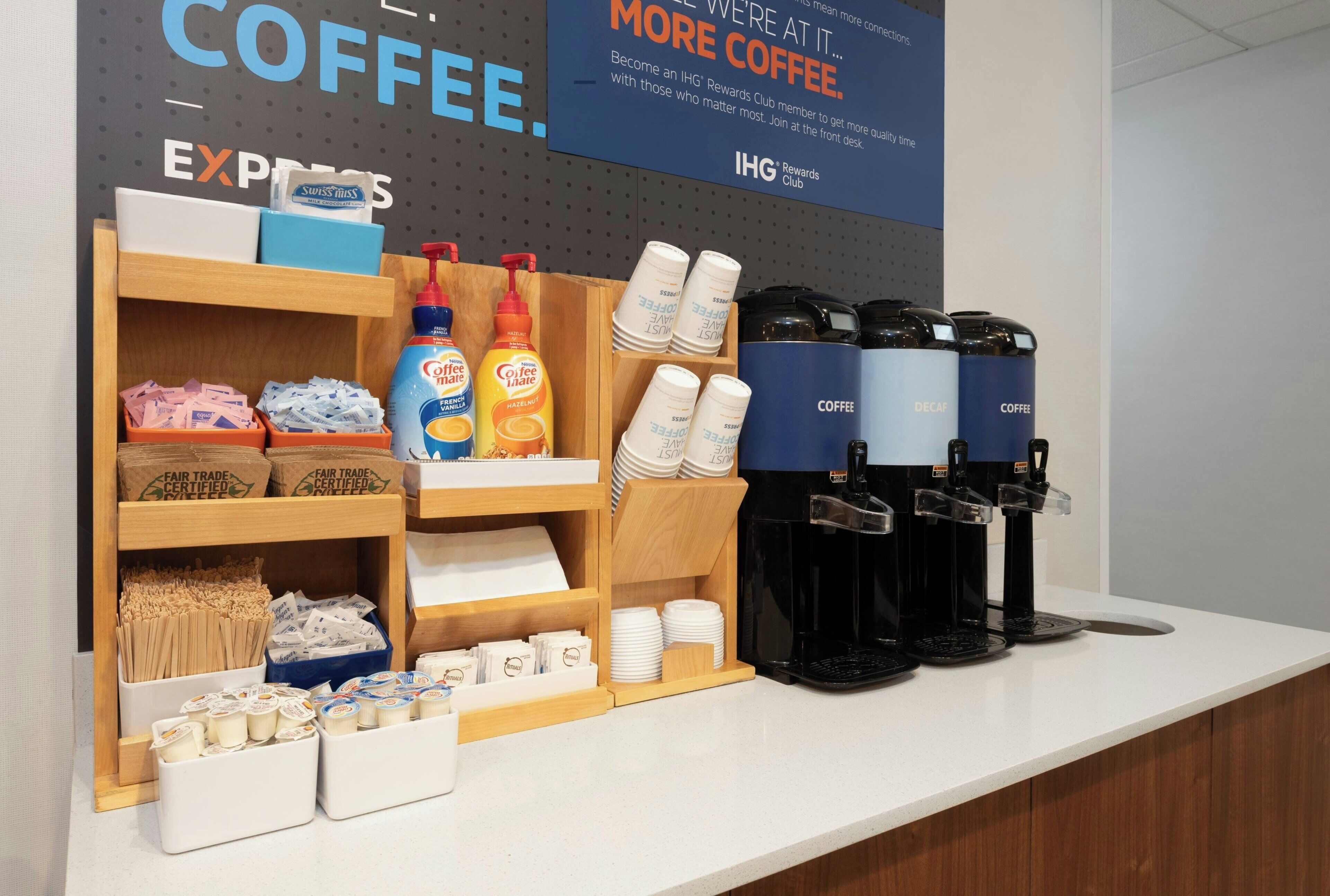 A coffee station with a display of coffee products, including coffee makers and coffee pods.