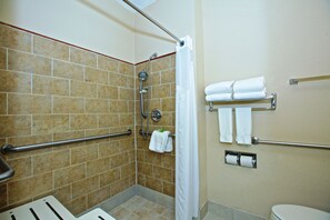 A shower area with a grab bar, a toilet, and a towel rack with towels. - Holiday Inn Express & Suites Acworth - Kennesaw Northwest by IHG (Acworth)
