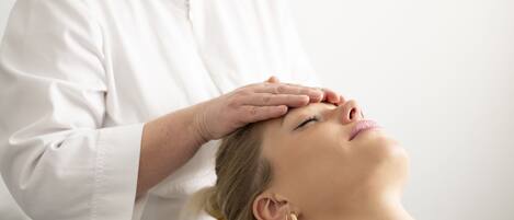 A person receiving a head massage.
