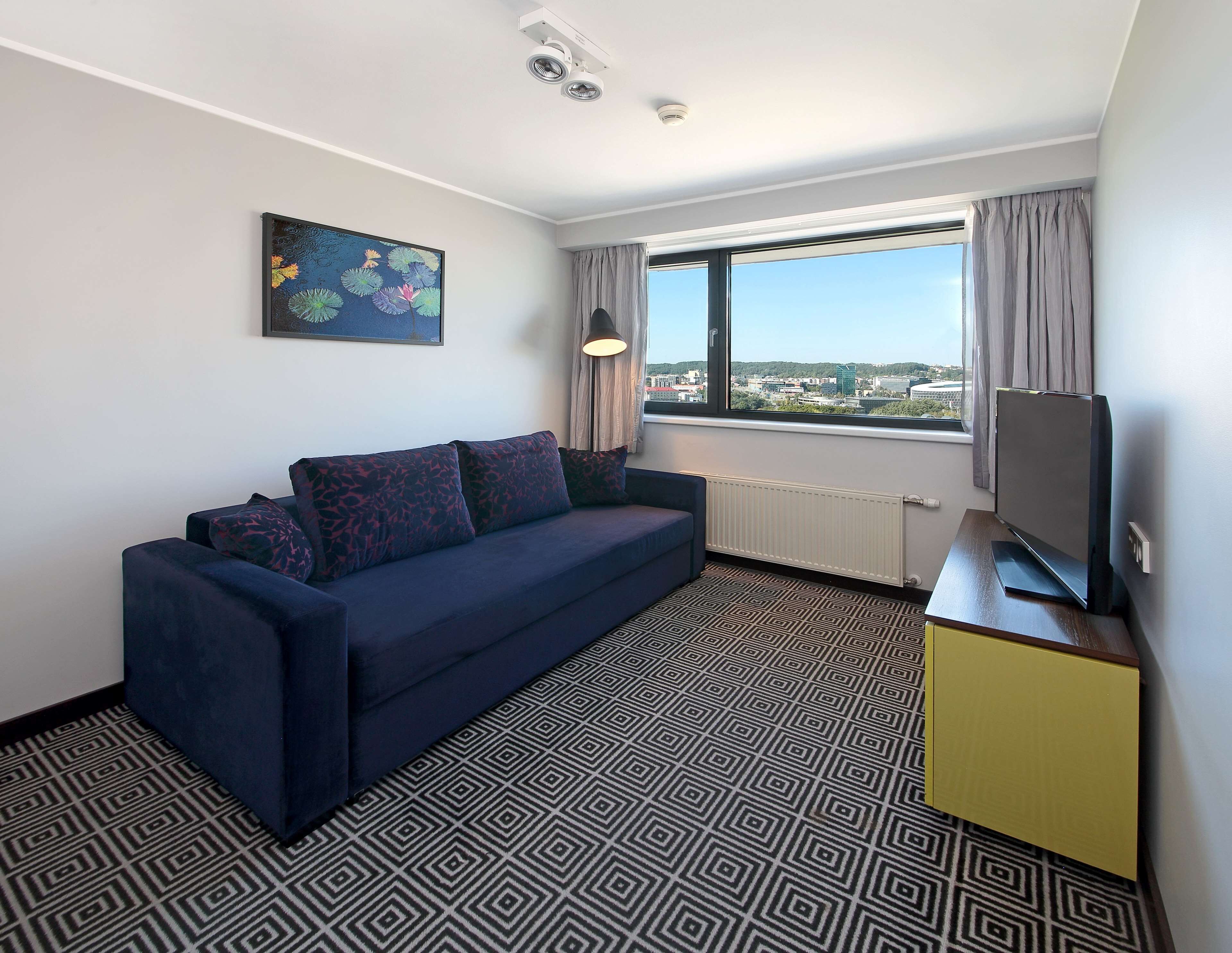 family room | 1 bedroom, minibar, in-room safe, desk