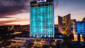 A high-rise hotel with a modern design, featuring a prominent Radisson sign. - Radisson Blu Hotel Lietuva (Vilnius)