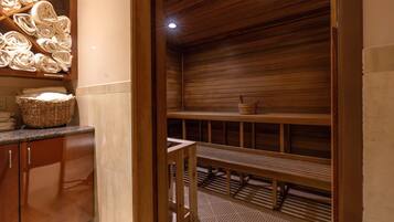 A sauna room with wooden benches and a wooden ceiling.