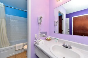 A bathroom with a shower, toilet, and sink. - The Maverick Motel, Main Street USA Collection by PNW Hospitality (Klamath Falls)