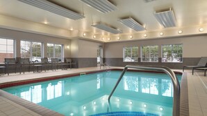 An indoor swimming pool with clear water, a tiled edge, and a metal ladder. - Residence Inn by Marriott Buffalo Galleria Mall (Buffalo)