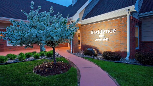 A Marriott Residence building with a brick facade, a tree in the foreground, and a pathway leading to the entrance. - Residence Inn by Marriott Buffalo Galleria Mall (Buffalo)