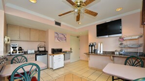 A kitchen with a dining area, a ceiling fan, a microwave, a toaster, and a television. - Anthony Inn (Anthony)