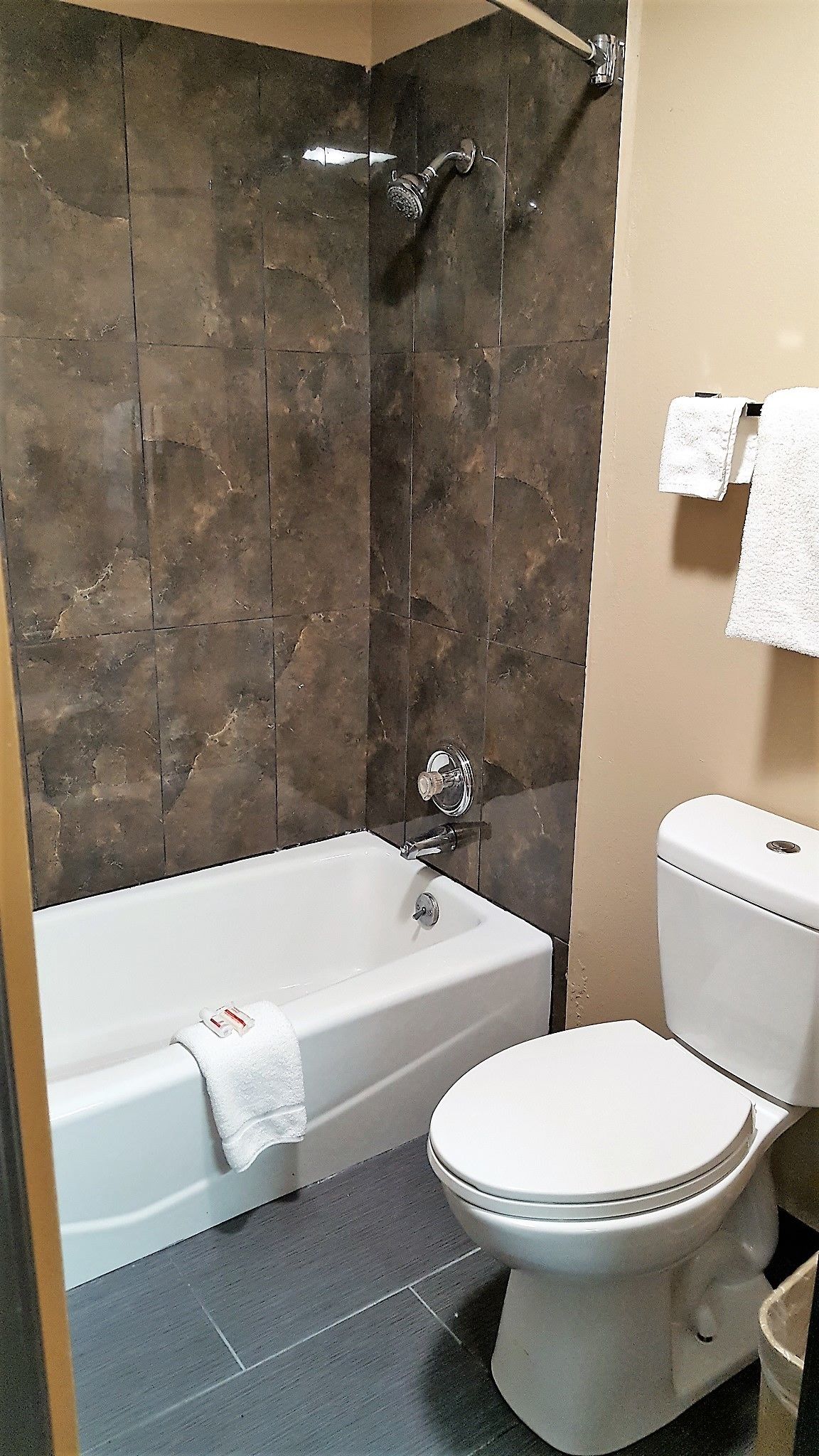 A bathroom with a bathtub, toilet, and a shower.