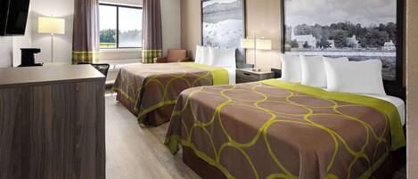 A hotel room with two beds, a desk, a TV, and a large window with a view of a body of water and buildings.