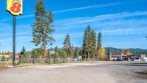 A Super 8 motel with a clear view of the surrounding forest and mountains. - Super 8 by Wyndham St. Regis (St. Regis)
