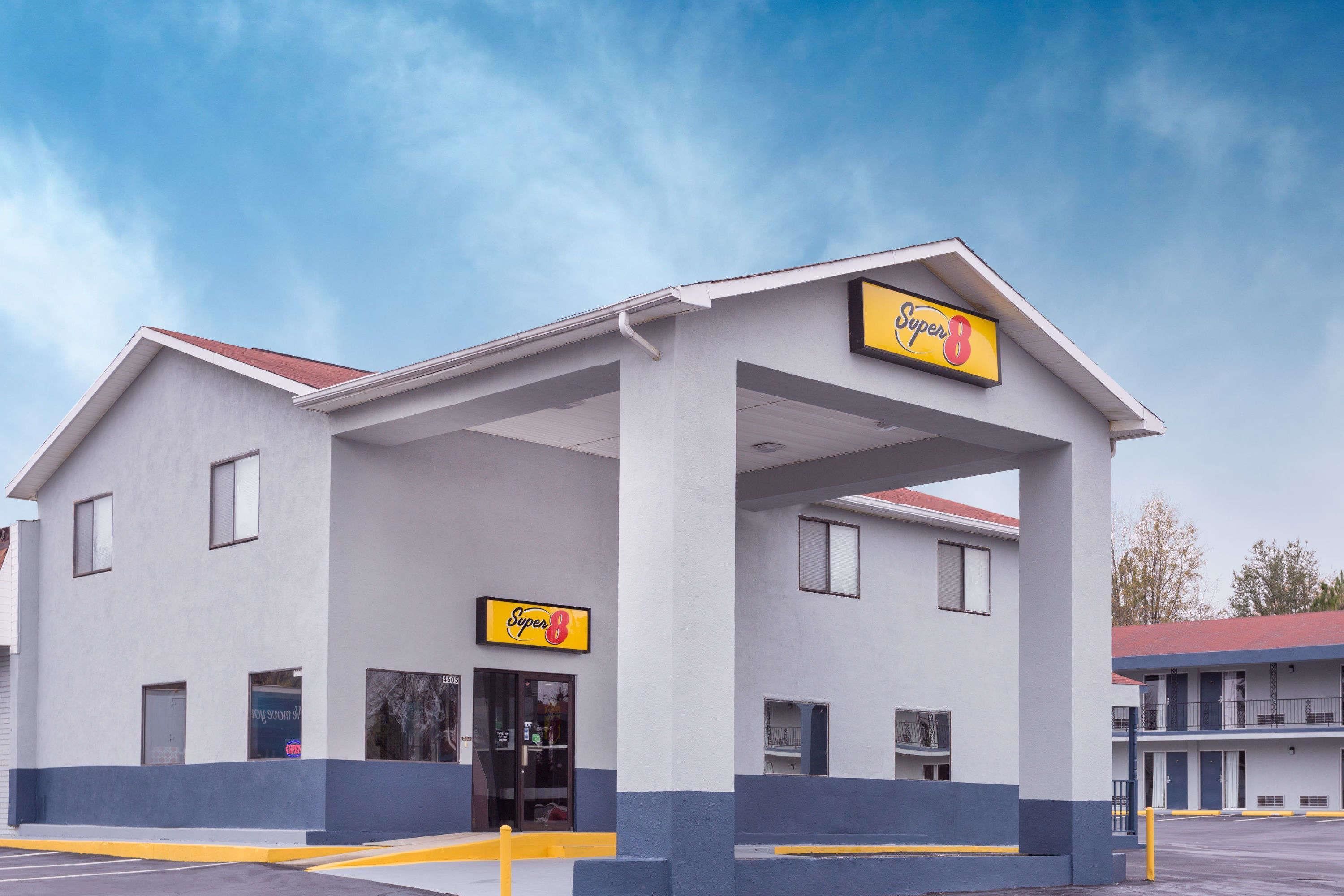 A Super 8 motel with a simple, two-story structure, a covered front entrance, and a parking lot.
