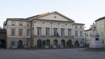 A historic building with a classical facade, arched windows, and a central entrance.