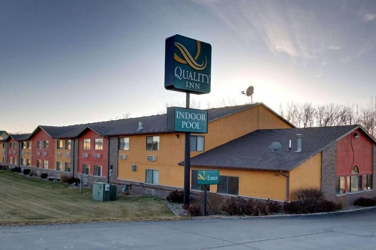 A Quality Inn with an indoor pool, multiple-story buildings, and a clear sky.