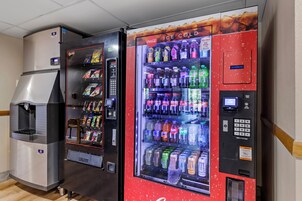 Una máquina expendedora con una sección de Coca-Cola bien fría y un dispensador de bebidas.