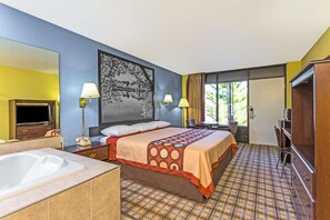 A hotel room with a large bed, a separate bathroom with a bathtub, a desk, and a television. - Super 8 by Wyndham Jessup/Baltimore Area (Jessup)