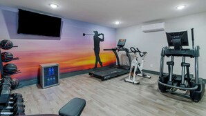 A gym with a treadmill, elliptical, and weights. - Clarion Pointe McDonough (McDonough)
