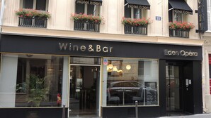A building with a 'Hotel Eden' sign, a 'Wine & Bar' establishment, and an 'Eden Opera' theater. - Hotel Eden Opéra (Paris)