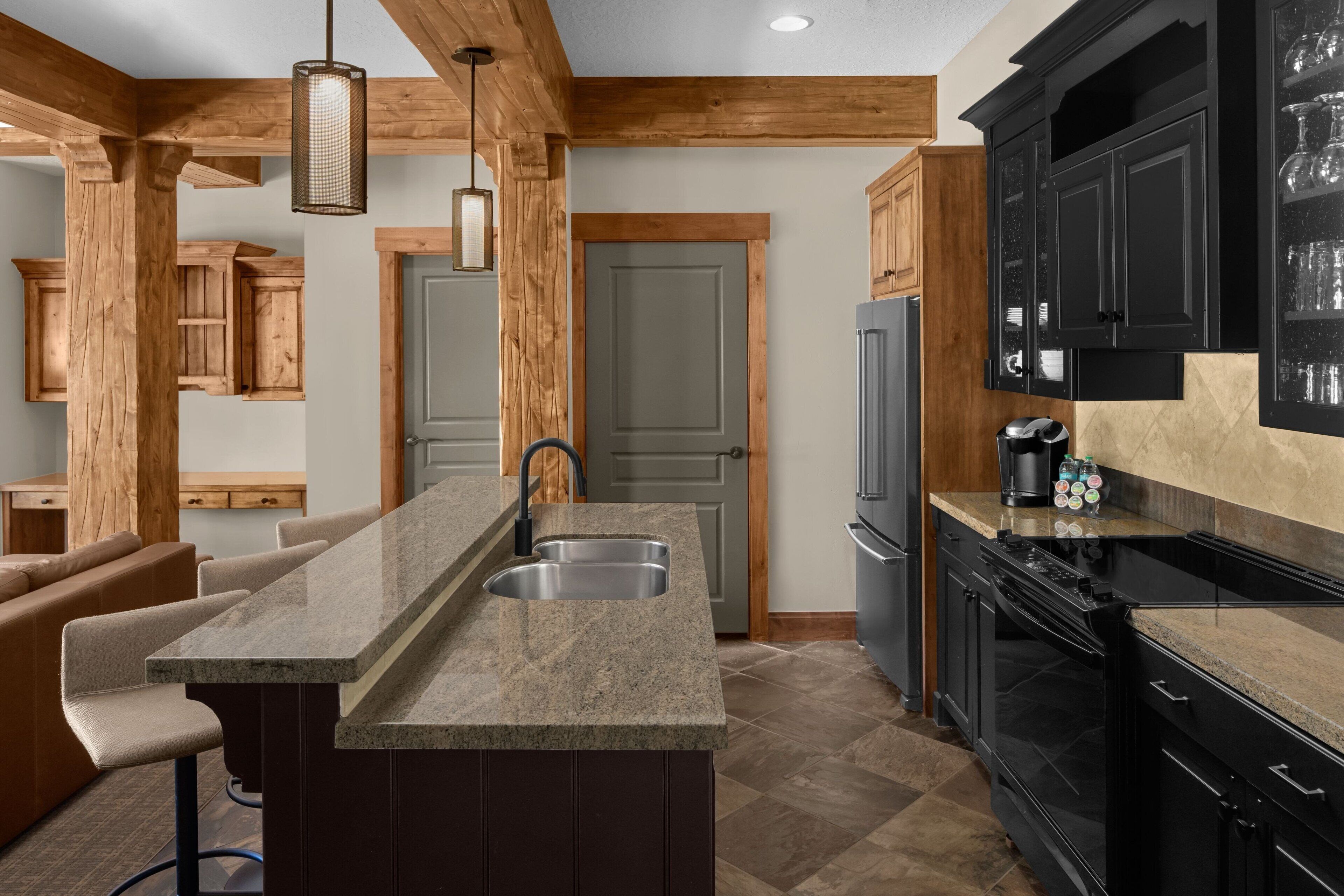 A kitchen with granite countertops, wooden cabinets, and a built-in stove.