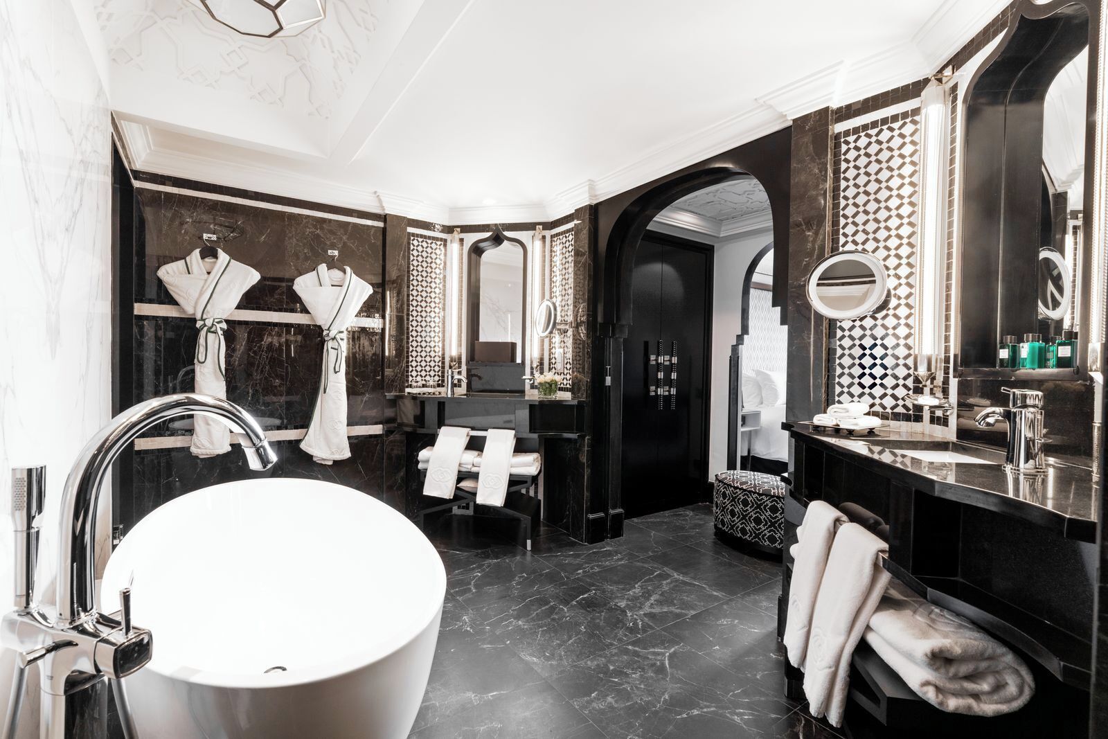 A modern bathroom with a large freestanding bathtub, a separate vanity with a mirror, and a shower area.