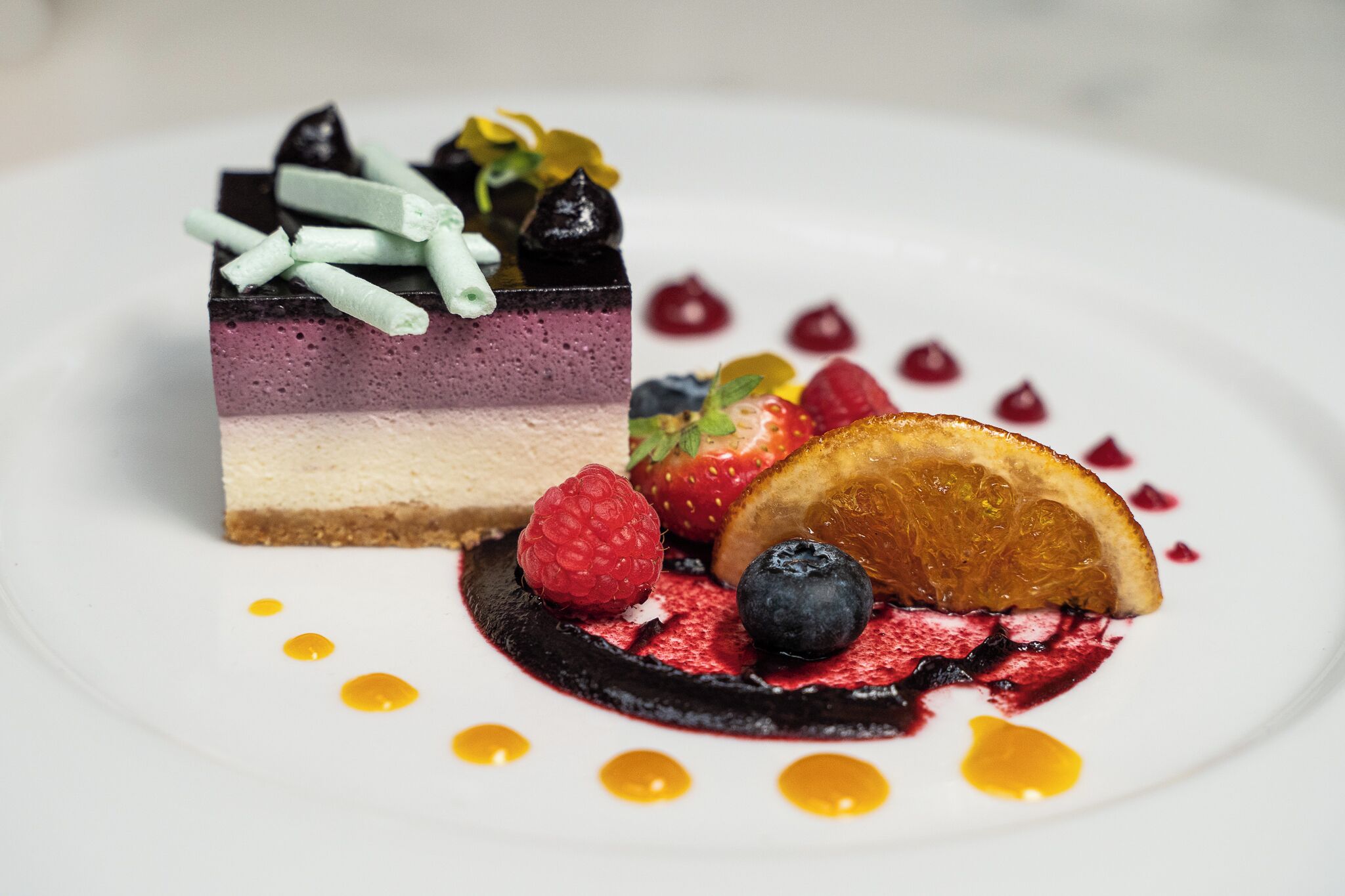 A dessert with layered cake and berries.