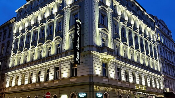 A historic building with ornate architecture, a prominent sign for 'Hotel Grun & Schubert', and a 'No Entry' sign visible on the street. - Green Garden Hotel (Prague)