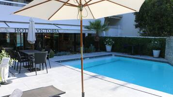 Seasonal outdoor pool, open 8:00 AM to 8:00 PM, pool umbrellas