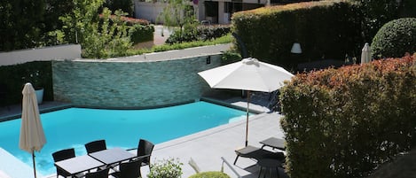Outdoor pool, open 8:00 AM to 8:00 PM, pool umbrellas, pool loungers
