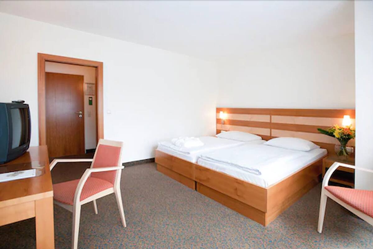 Standard Double Room | Minibar, in-room safe, blackout curtains, iron/ironing board