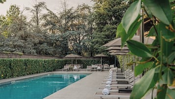 Seasonal outdoor pool, open 10:00 AM to 8:00 PM, pool umbrellas