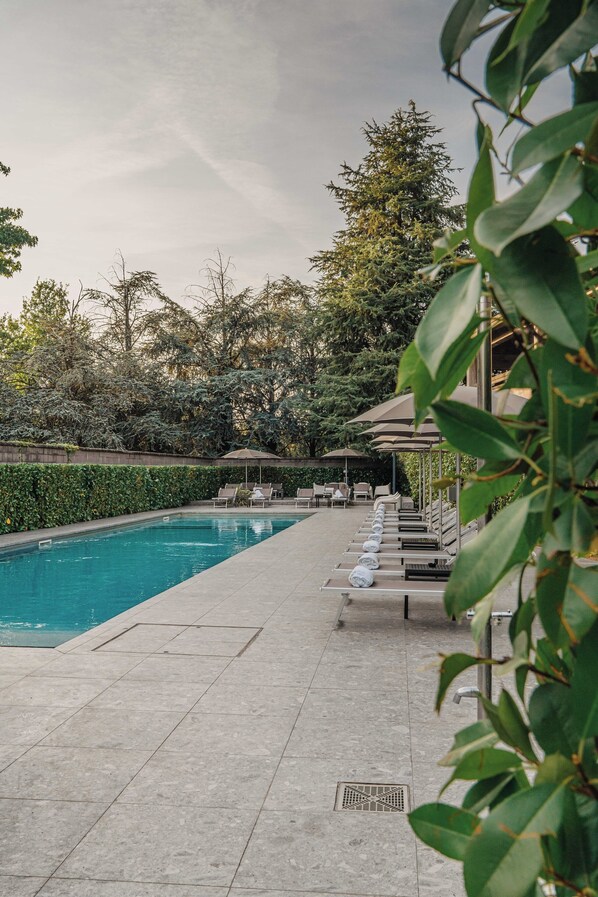 Seasonal outdoor pool, open 10:00 AM to 8:00 PM, pool umbrellas