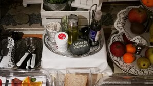 A buffet table with various food items including meats, bread, and desserts. - Airport Hotel Filderpost (Stuttgart)