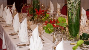 A table set for a formal dinner with white napkins, silverware, and wine glasses. - Airport Hotel Filderpost (Stuttgart)