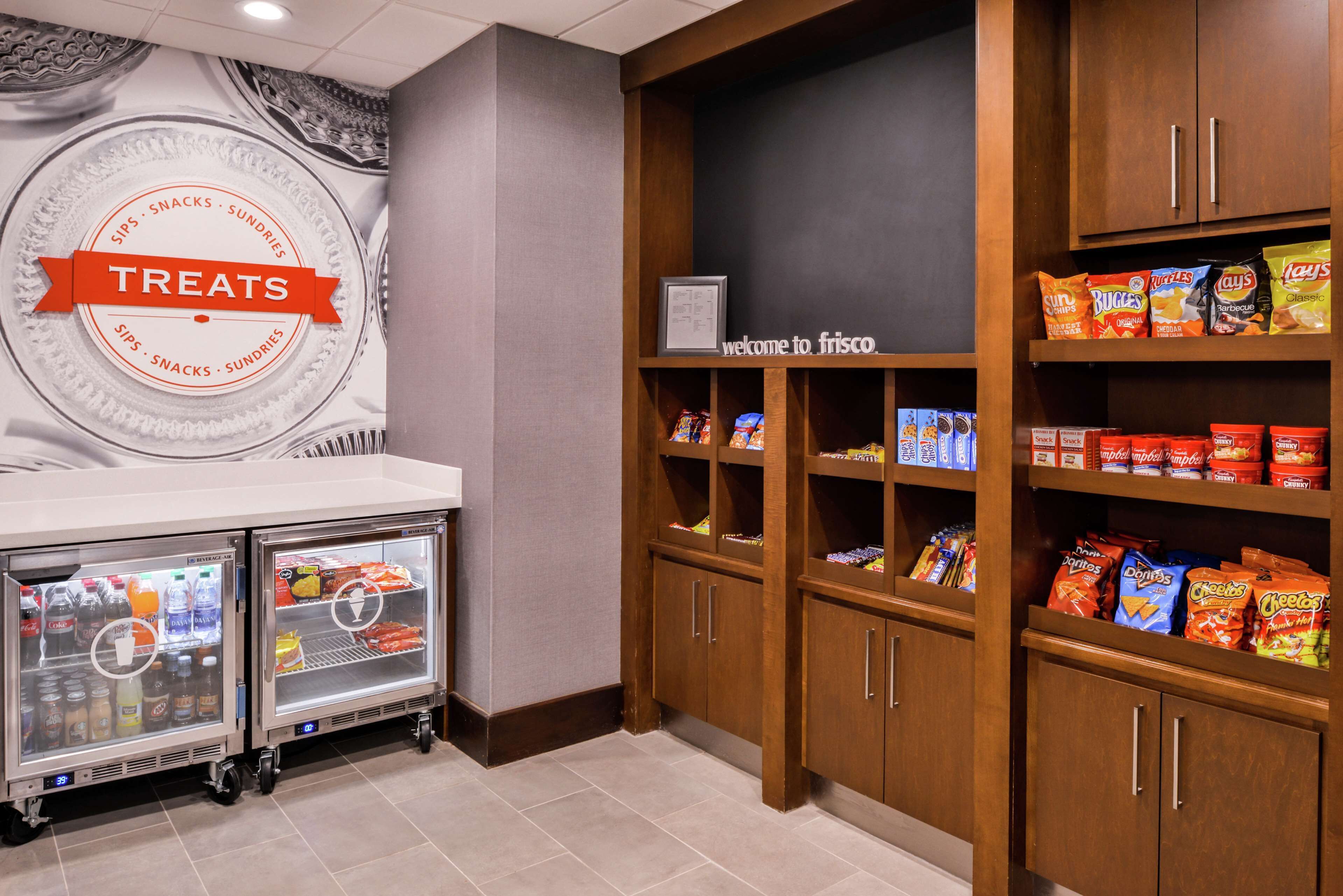 A refrigerated treat display with snacks and beverages.