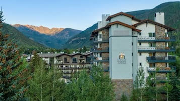 A multi-story building with a sign reading "Lodge Tower" in a mountainous area.