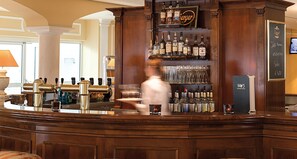 A bar area with a wooden counter, various bottles of liquor, and a chalkboard menu. - Victor's Residenz-Hotel Erfurt (Erfurt)