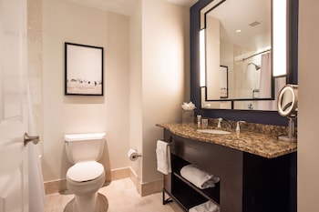 Combined shower/tub, free toiletries, hair dryer, bathrobes at Magnolia Hotel Houston, A Tribute Portfolio Hotel