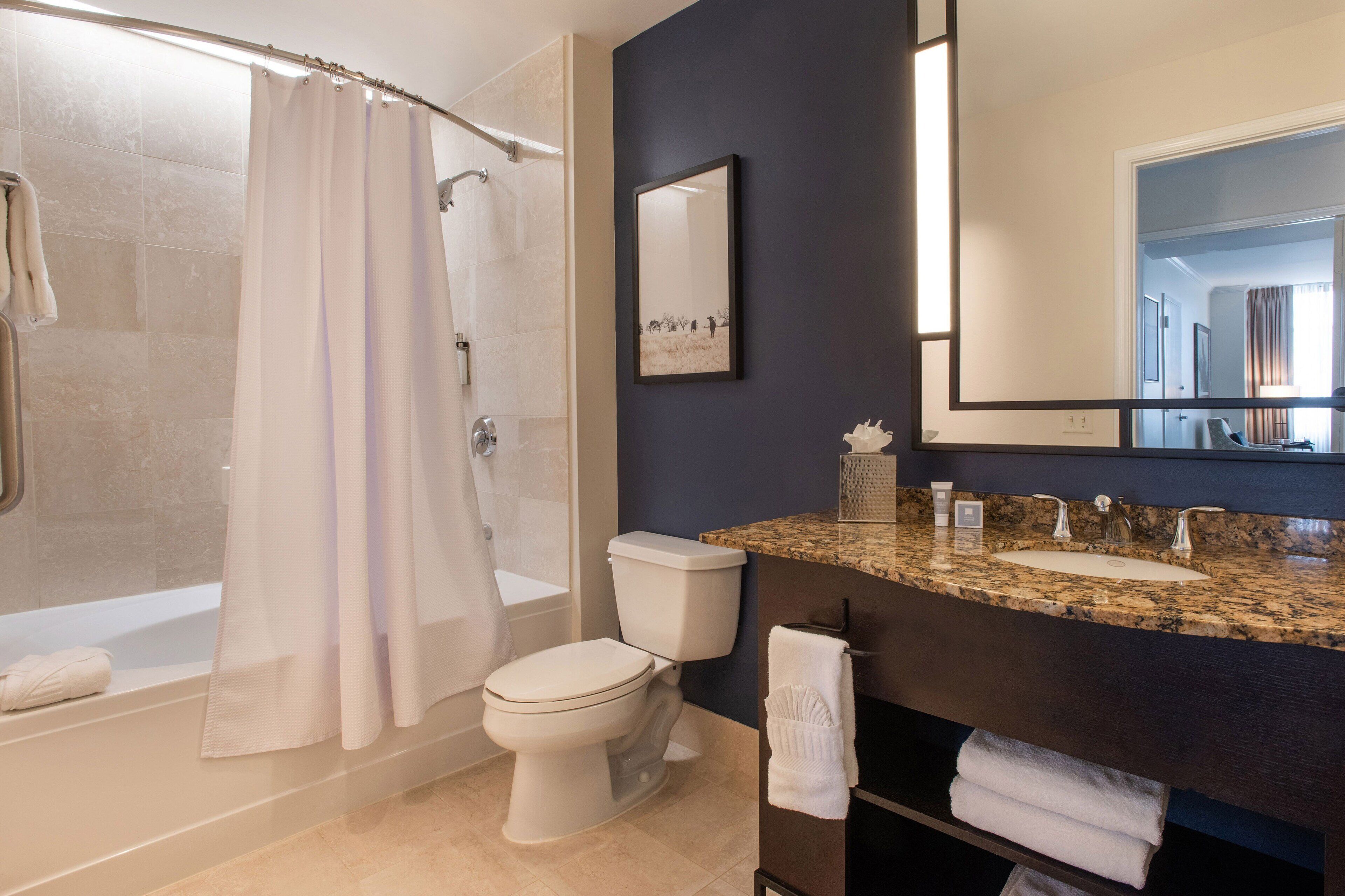 Un baño moderno con ducha, inodoro y lavamanos.