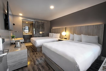 Poolside Double Queen, 2 Queen Beds | Desk, laptop workspace, blackout drapes, bed sheets at Oasis at Gold Spike