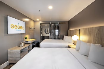 Poolside Double Queen, 2 Queen Beds | Desk, laptop workspace, blackout drapes, bed sheets at Oasis at Gold Spike