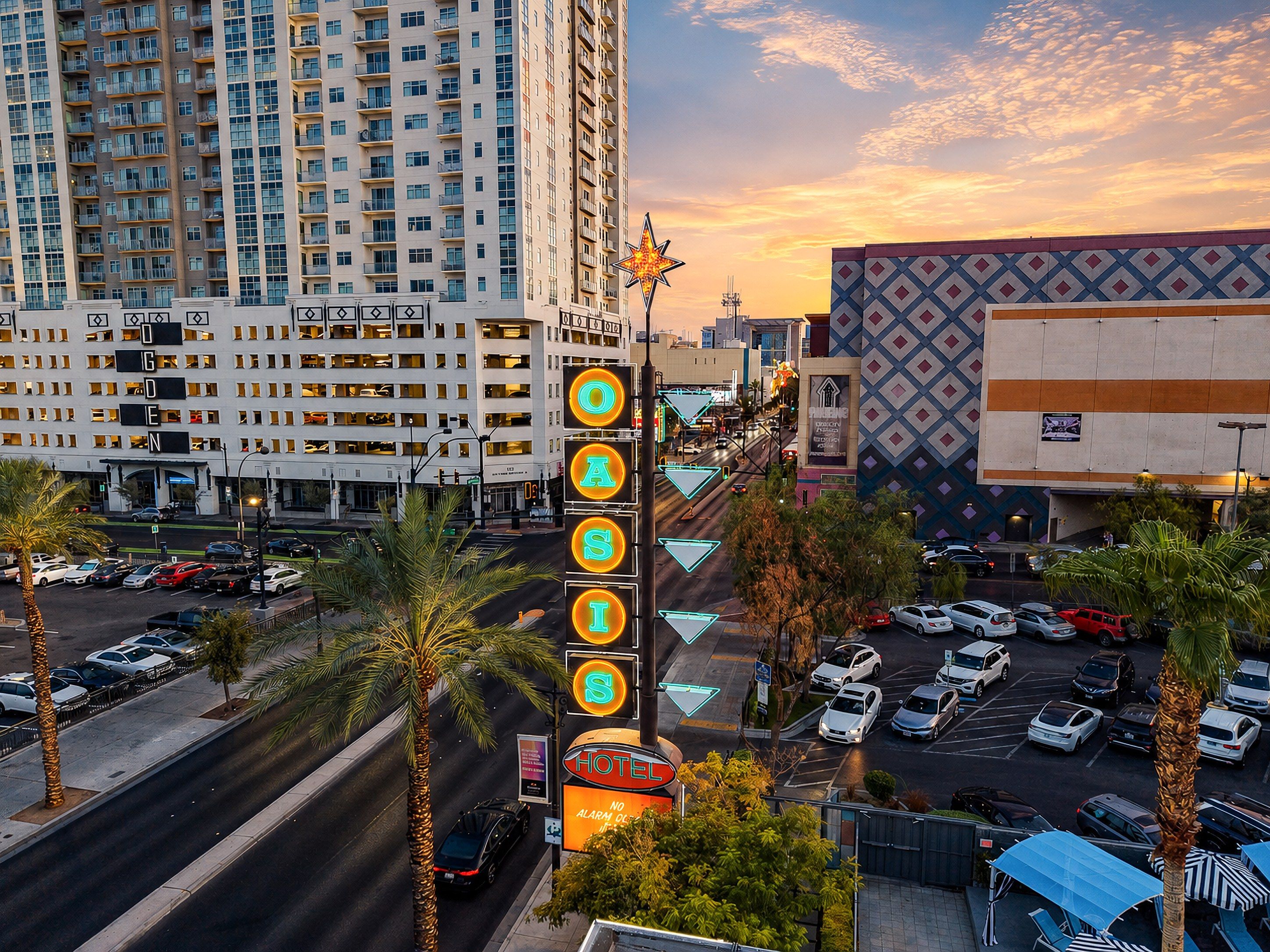 A hotel with multiple floors, a parking lot, and a street with traffic lights.