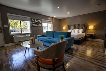 Poolside King Suite | Living area | TV at Oasis at Gold Spike