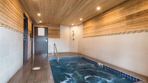 A spa area with a hot tub, wooden ceiling, tiled walls, and a metal ladder. - Best Western Mt. Hood Inn (Government Camp)
