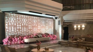 A modern lobby with a seating area, a decorative wall, and a reception desk. - Holiday Inn Riyadh-Olaya by IHG (Riyadh)