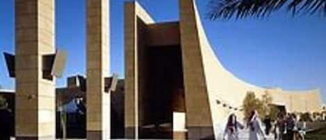 A modern building with a curved facade and large pillars.