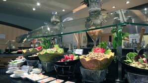 A buffet with various dishes and salads displayed in clear bowls and containers. - Holiday Inn Riyadh-Olaya by IHG (Riyadh)