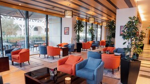 A modern lobby with seating areas, large windows, and indoor plants. - Holiday Inn Riyadh-Olaya by IHG (Riyadh)