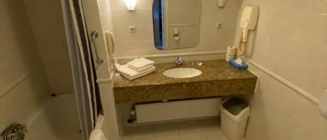 A bathroom with a bathtub, a sink, a toilet, and a shower.