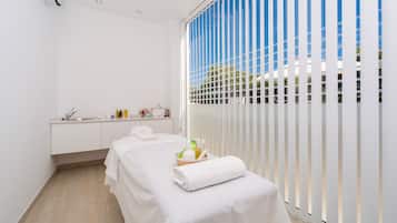 Simple, elegant room with a single bed, white cabinet, and large window.