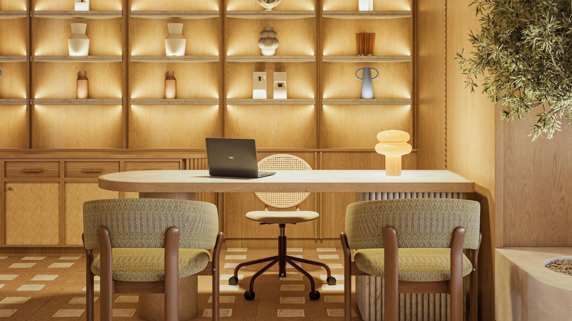 Un interior moderno con una mesa redonda, dos sillas estampadas, una laptop y un estante en la pared con varios objetos decorativos.