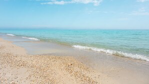 A beach with clear water, pebbles, and a clear sky. - Canvas by Mitsis Alexander the Great (Kassandra)